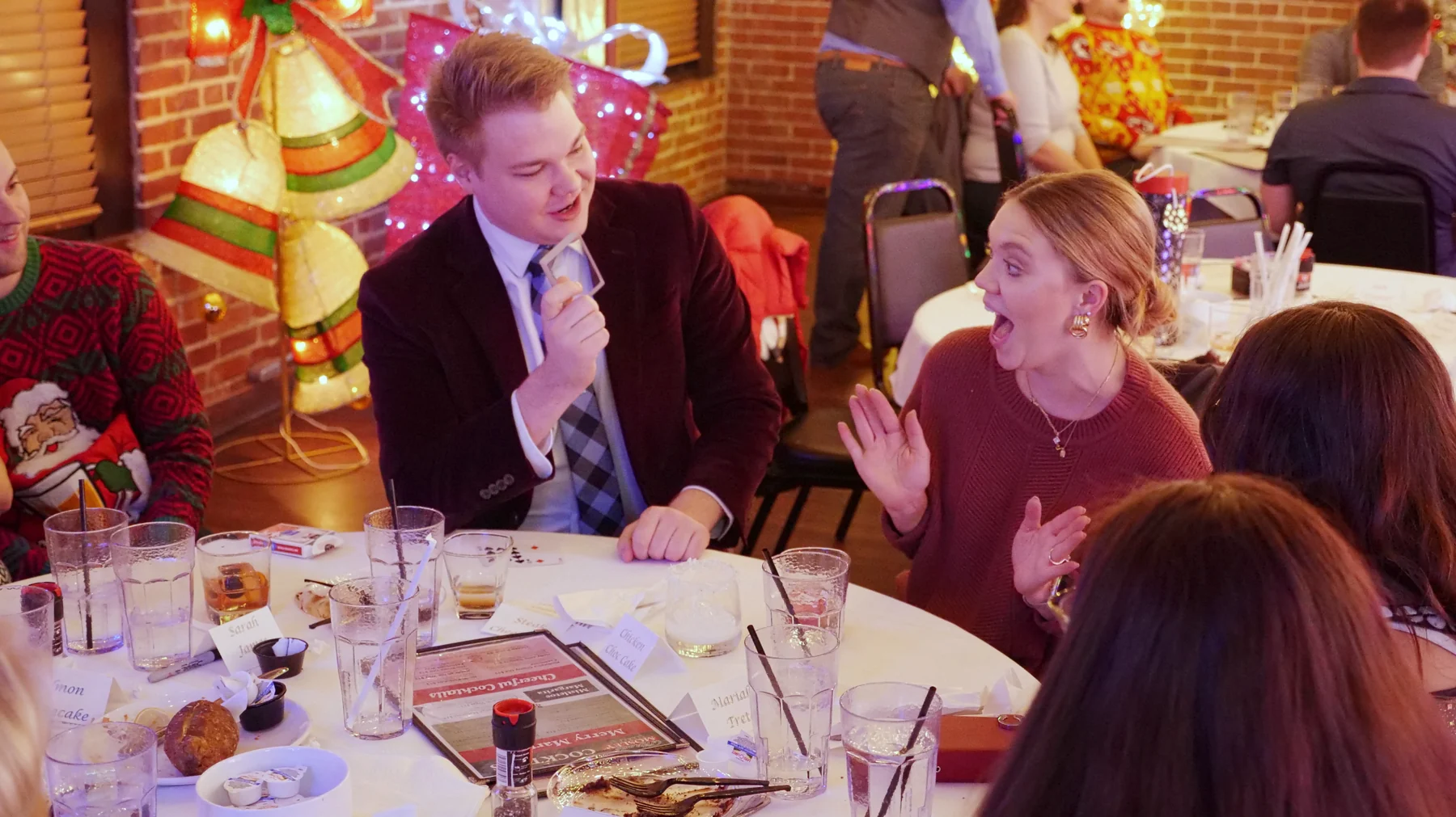 A surprised guest reacts to Chris Marvell’s close-up magic at a holiday party