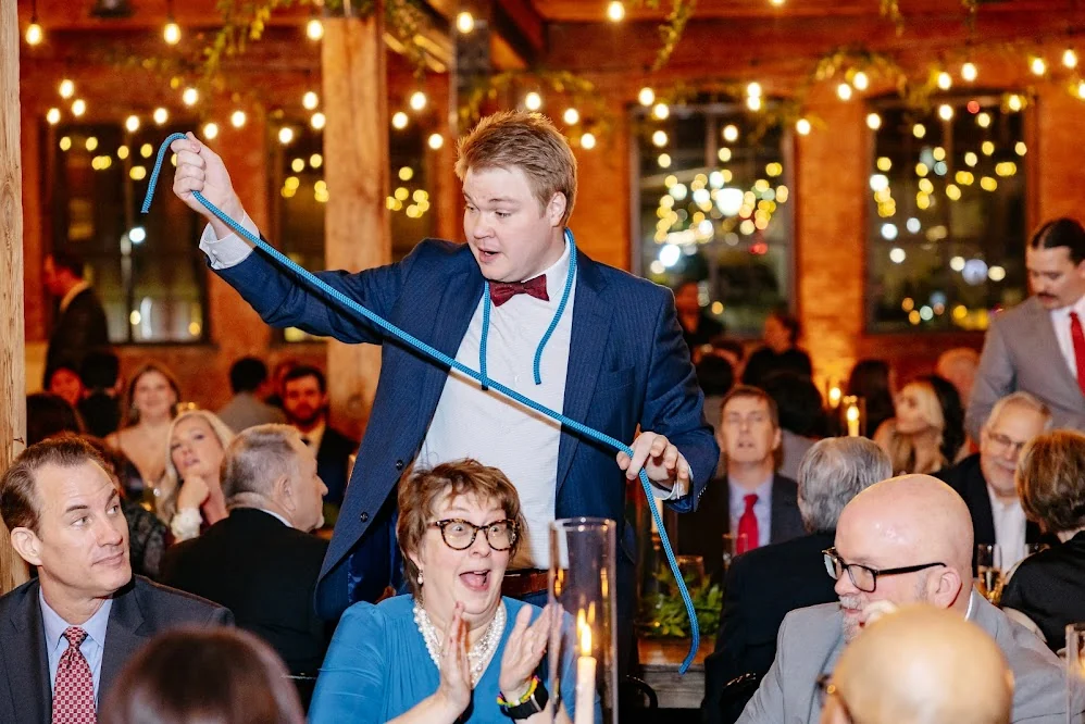 Chris Marvell performing rope magic among delighted wedding guests